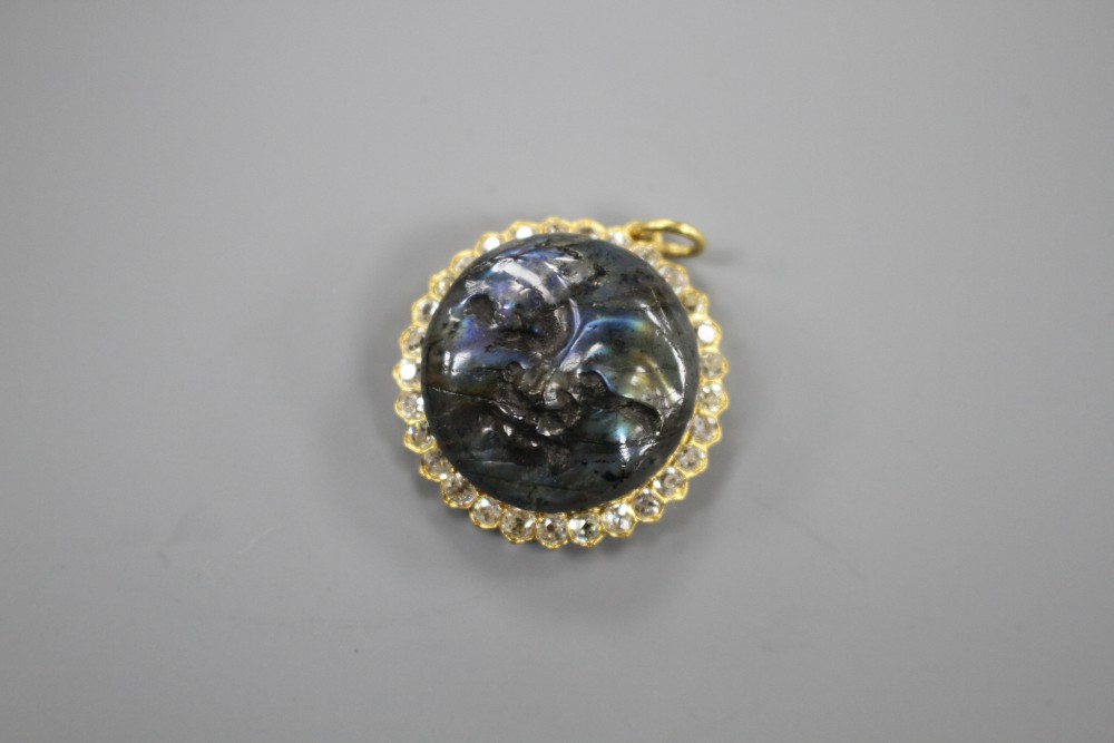 A 20th century yellow metal, diamond and carved labradorite? moon face pendant, 26mm, gross weight 7.2 grams.